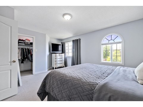 A bedroom with a large bed and a wardrobe.