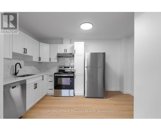 A modern kitchen with stainless steel appliances and white cabinets.