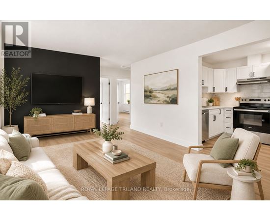 A modern living room with a flat screen TV, a sofa, a coffee table, and a painting on the wall.
