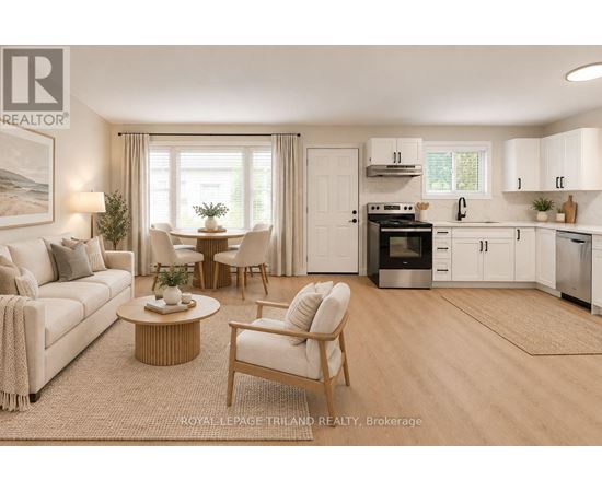A well-lit, modern kitchen and living room with white furniture and a wooden coffee table.