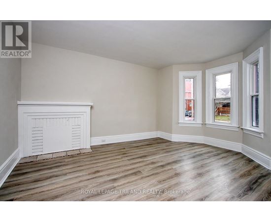 A room with wooden floors and white walls.
