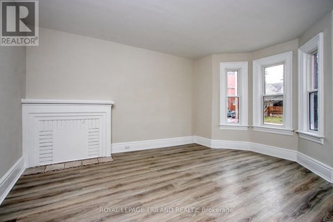 A room with wooden floors and white walls.