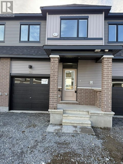 A modern house with a grey and black exterior and a glass door.