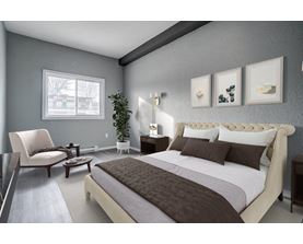 A bedroom with a large bed and a chair.