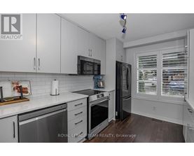 A kitchen with white cabinets and a stainless steel dishwasher.