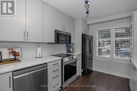 A kitchen with white cabinets and a stainless steel dishwasher.