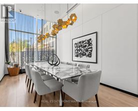 A modern dining room with a glass table and chairs.