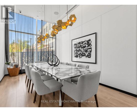 A modern dining room with a glass table and chairs.