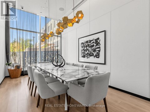 A modern dining room with a glass table and chairs.