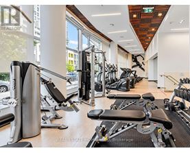 A gym with a variety of equipment including treadmills, stationary bikes, and weight machines.