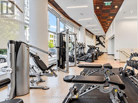 A gym with a variety of equipment including treadmills, stationary bikes, and weight machines.