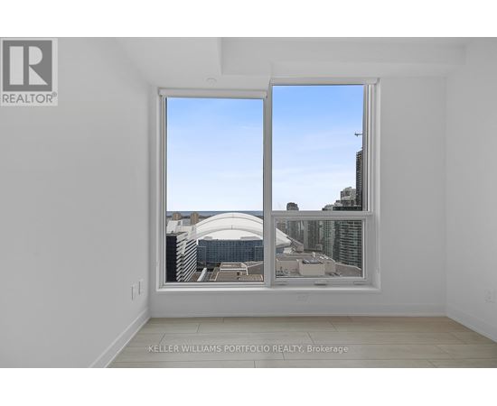 A room with a large window showing a cityscape.