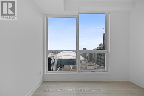 A room with a large window showing a cityscape.