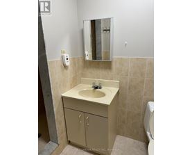 A bathroom with a sink and a mirror.