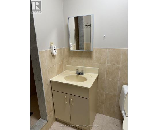 A bathroom with a sink and a mirror.