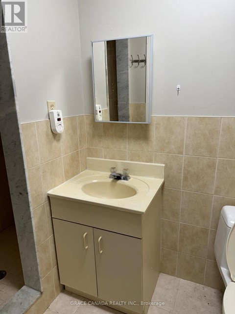 A bathroom with a sink and a mirror.