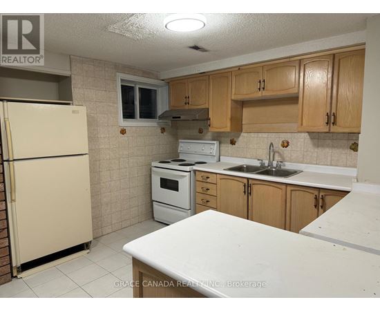 A kitchen with a white counter top and wooden cabinets.