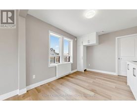A room with a window showing a house and a brokerage logo.