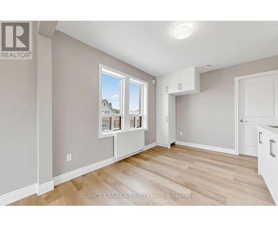 A room with a window showing a house and a brokerage logo.