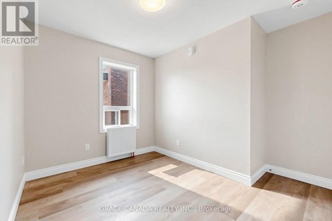 A room with a window and a radiator on the floor.