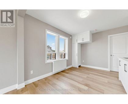 A room with a window showing a house and a brokerage logo.