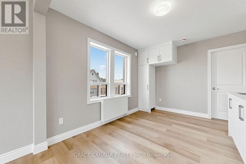 A room with a window showing a house and a brokerage logo.