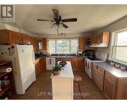 A kitchen with wooden cabinets and a white refrigerator.
