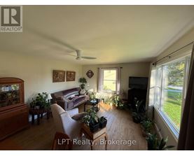 A living room with a couch, a television, and a fish tank.