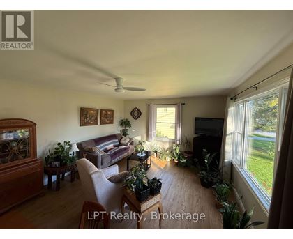 A living room with a couch, a television, and a fish tank.