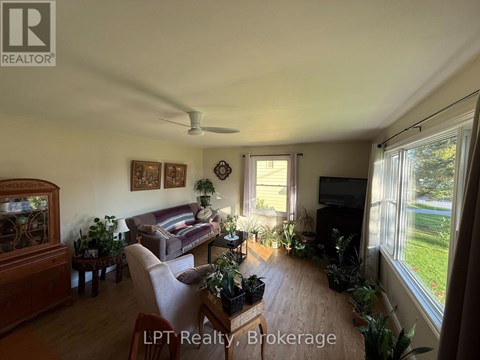 A living room with a couch, a television, and a fish tank.