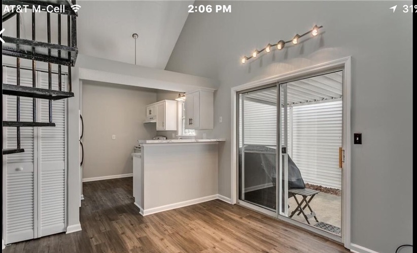 A kitchen with a bar and a chair is shown.