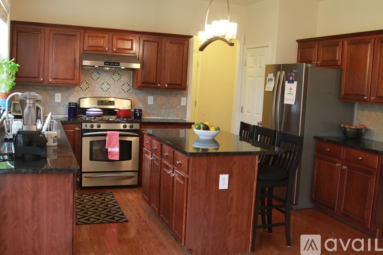 A kitchen with wooden cabinets and a black countertop.