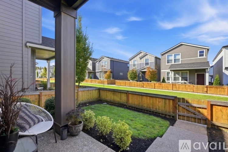 A backyard with a small garden and a patio area.