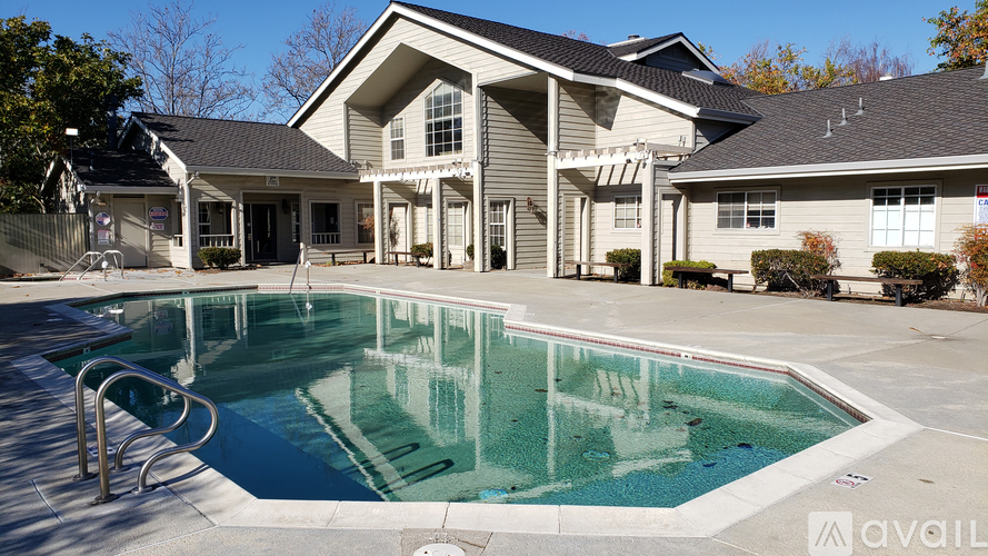 A pool in front of a house with a sign that says "available".