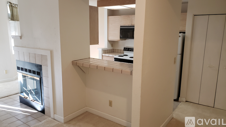 A kitchen with a stove top oven and a refrigerator.
