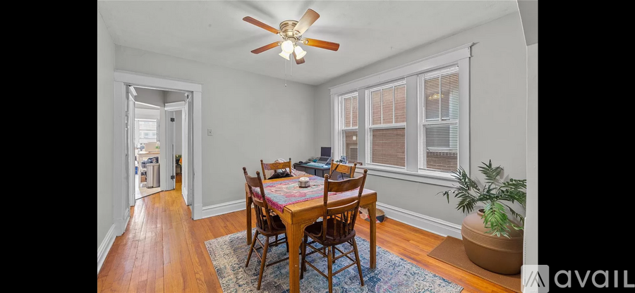 A dining room with a wooden table and chairs.