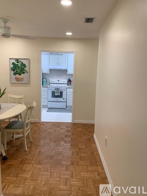 A kitchen with a table and chairs in it.