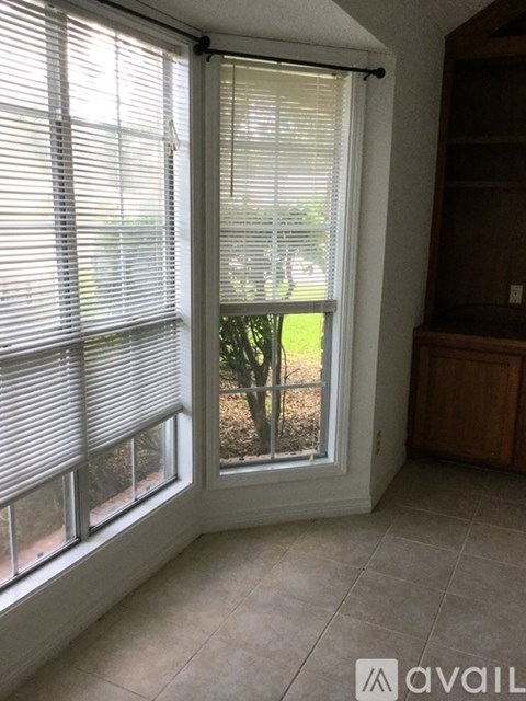 A room with a sliding glass door and a tiled floor.