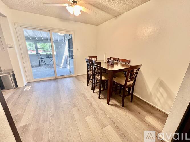 A dining room with a wooden table and chairs.