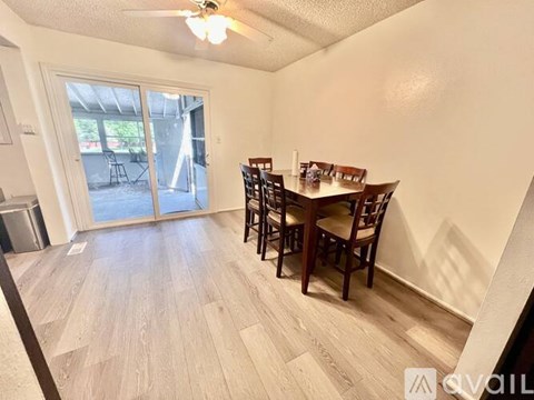 A dining room with a wooden table and chairs.