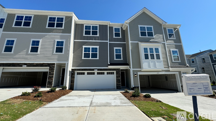 A modern two-story residential building with a garage.