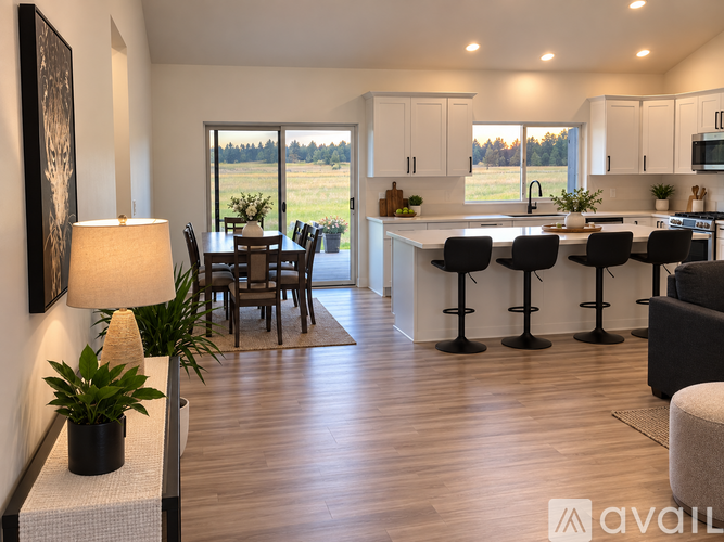 A modern kitchen with a dining table and chairs.