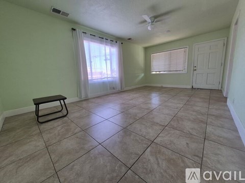A room with a bench and a window with blinds.