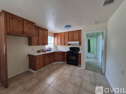 A kitchen with wooden cabinets and a black oven.