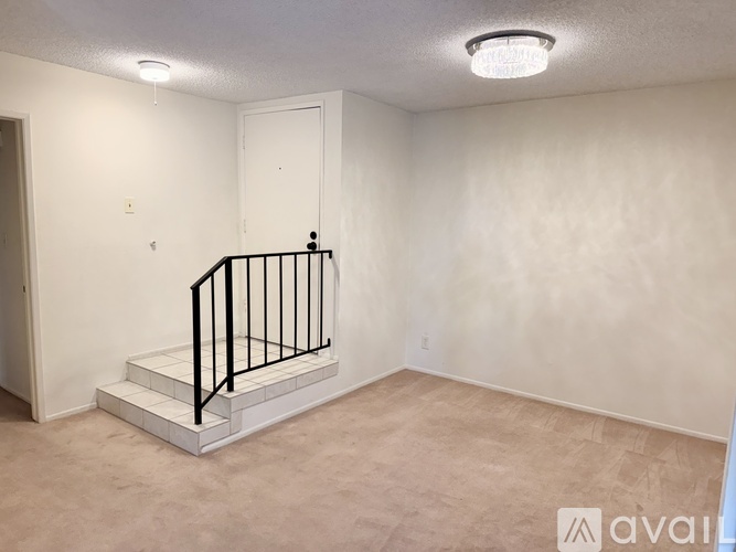 A room with a staircase and a door.