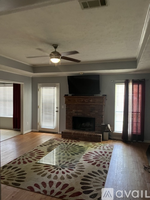 A living room with a fireplace and a television.