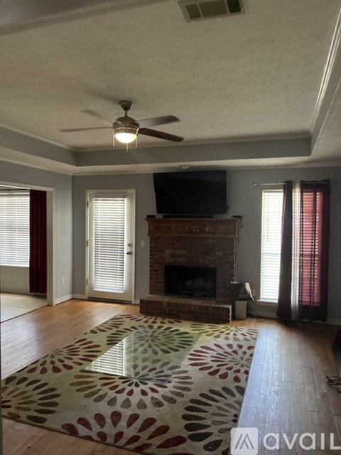 A living room with a fireplace and a television.