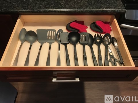 A drawer full of utensils including spatulas and tongs.