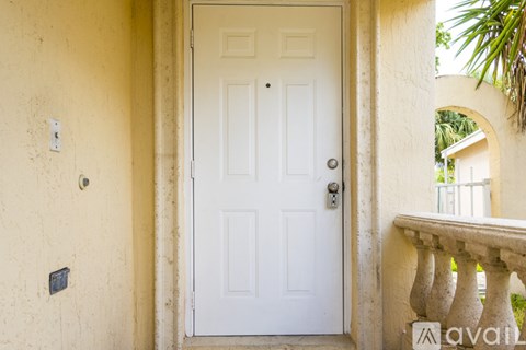 A white door is open to a balcony.