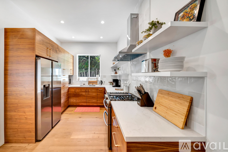 A modern kitchen with wooden cabinets and stainless steel appliances.